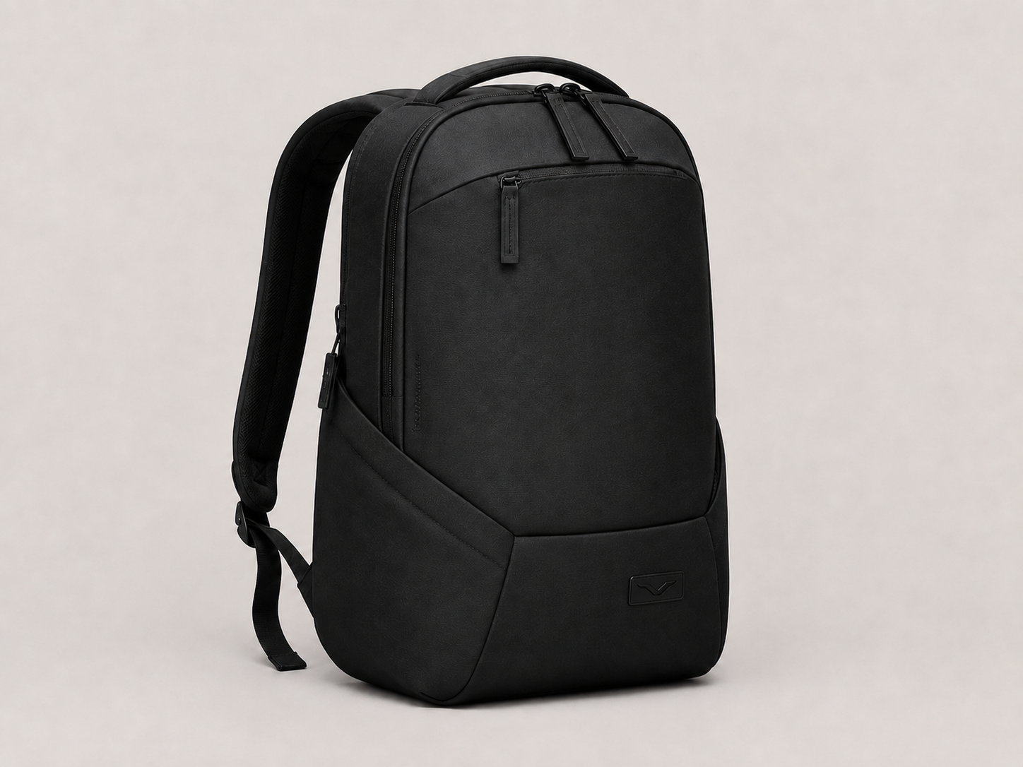 VELT Business Backpack — matte black with debossed V logo